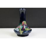 Moorcroft Orchid pattern vase having a blue ground with tube lined floral detailing. Impressed marks