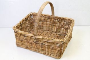 Large rectangular wicker log basket with loop carry handle, approx 61cm long