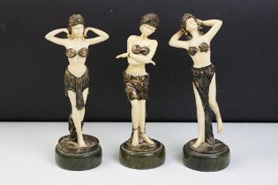 Three Art Deco style resin figures in the form of women in matching costumes. Measures 22cm tall.