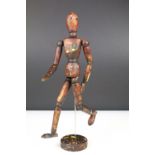 Wooden artists posable drawing aid figure raised on a round wooden base. Measures 33cm tall.