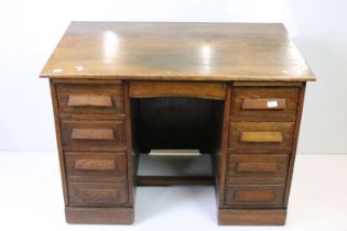 Early 20th century Oak Twin Pedestal Desk with an arrangement of seven drawers all with long block