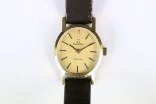 A ladies Omega Geneve wristwatch, gold dial with baton markers on original strap..