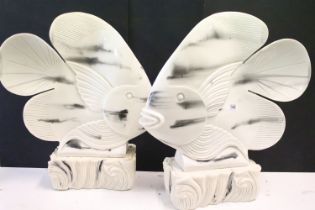 Pair of large resin Carp fish, with marble effect finish, raised on textured rectangular carved