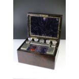 19th Century rosewood travelling vanity box, the lid opening to a fitted interior housing glass