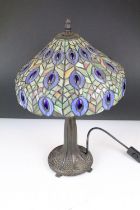 Tiffany style table lamp with leaded glass shade & bronzed textured metal base, raised on four feet.