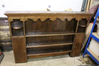 18th or 19th century Oak Dresser Top with shaped frieze and an arrangement of shelves and cupboards,