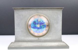 Liberty & Co. pewter mantel clock, the rectangular beaten case with a circular blue enamel &