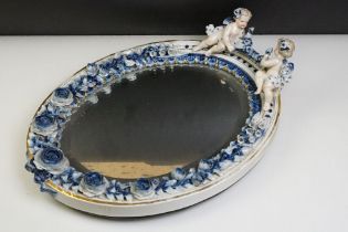 Sitzendorf porcelain dressing table mirror with blue & white floral encrusting, putti with garland