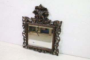 19th / Early 20th century Ornate Bevelled Edge Mirror, the wooden framed heavily carved with