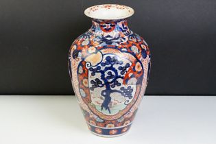 Japanese Imari baluster vase having blue and white underglaze detailing and red and gilt over