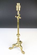 Early 20th century brass table lamp with pivoting top, raised on three hoof feet, approx 46.5cm high