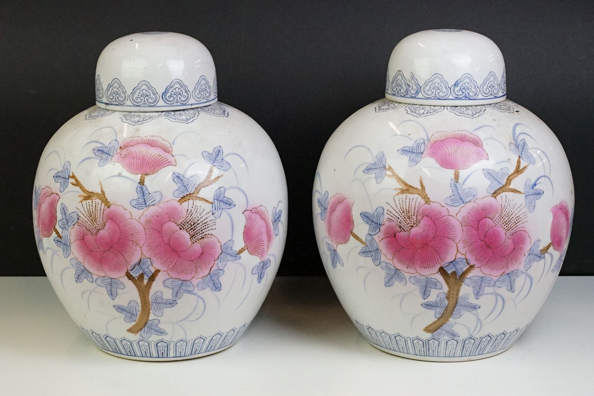 Pair of Chinese large ginger jars, each having printed pink and blue floral designs. Blue seal marks