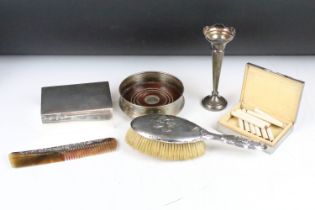 A collection of hallmarked sterling silver to include two cigarette boxes, bottle coaster, bud vase,