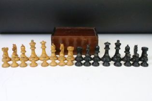 A set of early 20th century boxwood chess pieces within wooden box.