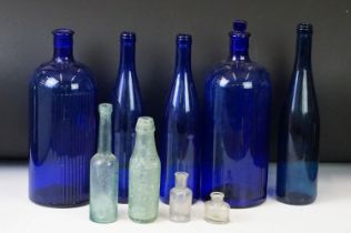 Collection of nine vintage glass bottles to include blue poison bottles, J.B. Bowler of Bath Codd