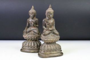 Pair of hollow cast bronze Buddha figurines each modelled seated on the lotus. Measures approx 23.