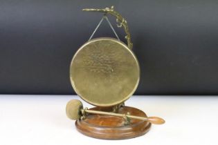 20th Century table top dinner gong having a round oak base with cast brass dolphin support with gong