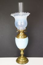 Early 20th Century oil lamp having a round stepped brass base with blue ceramic reservoir and