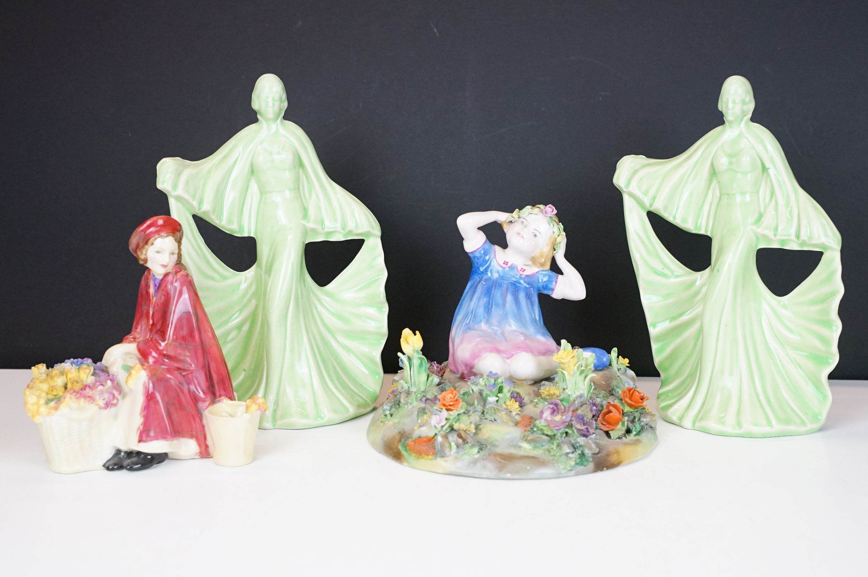 Group of four ceramic figures to include a Crown Staffordshire floral encrusted figure of a girl