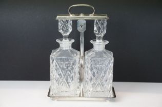 Early-to-mid 20th C silver plated tantalus with rectangular base and carry handle, housing two cut
