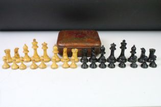 A set of early 20th century boxwood chess pieces within a Huntley & Palmers biscuit tin.