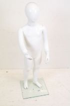 Child Full Size Shop Display Mannequin with plain white finish held on a clear square glass stand,