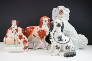 Group of four 19th century Staffordshire flatback mantel dog figures with painted details, featuring