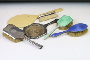 A hallmarked sterling silver brush and mirror set together with a silver and enamel brush..