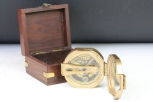 A contemporary brass cased compass within fitted wooden box.