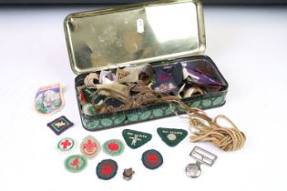 A small group of mixed scouting collectables to include a quantity of cloth badges, woggles....etc.