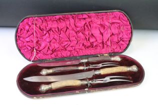 A late 19th century cased carving set, antler handles with hallmarked silver mounts, dated 1896.