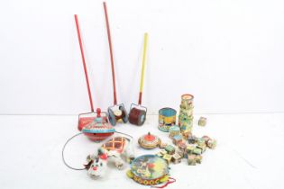 A small collection of vintage toys to include tin plate spinning top, roller toys, wooden blocks and