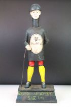 Cast iron reproduction Guinness advertising money box featuring a figure standing on a pedestal base