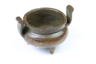 A Chinese brass Sensor / Mantra incense burner, round belly, three footed, character marks to