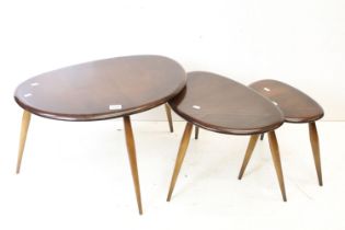 Ercol Nest of Three Dark Elm and Beech Pebble Tables, model no. 354, largest table 41cm high x