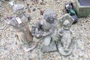 Collection of three reconstituted stone ornamental garden figures, to include a seated gnome,