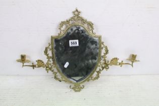 Brass Shield Shaped Girandole Wall Mirror with pierced foliate scroll frame and bevelled edge,