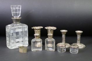 A collection of mixed sterling silver to include a pair of bud vases, pair of candlesticks, vanity