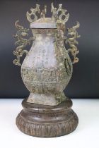 20th Century Chinese cast metal urn vase being incised with Chinese character marks to the sides