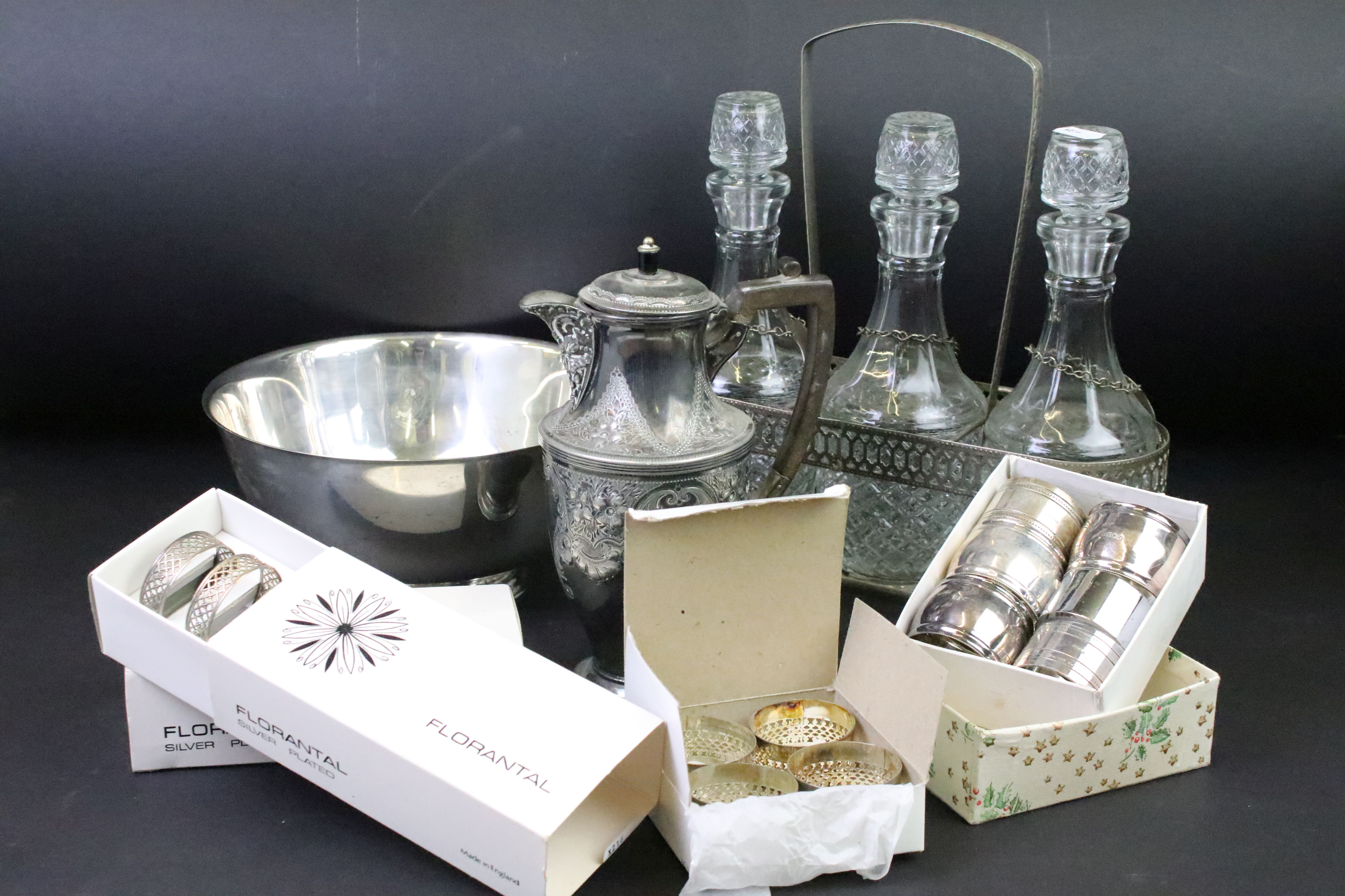 A group of mixed silver plate to include decanters, napkins rings, salad bowl ....etc..
