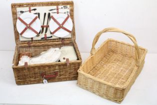 Wicker basket appointed with picnic set having plates, knives and forks, cork screw, wine glasses,