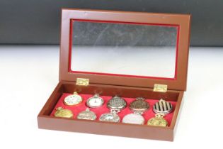 A collection of ten contemporary pocket watches contained within a display case.