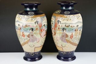 Large pair of Oriental cobalt blue ground baluster vases, with figural panels of females with