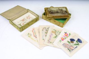 A collection of early 20th century world war one era silk postcards within to period boxes.