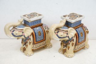 Pair of Chinese ceramic elephant stools modelled with trunks aloft, with blue, pink & brown glazed