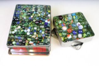 A collection of mixed marbles of various sizes and colours contained within two boxes.