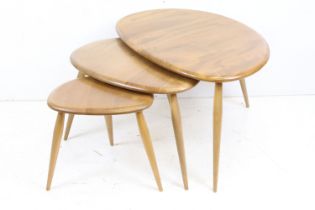 Ercol Pale Elm and Beech Nest of Three Pebble Tables, model 354, 65cm long x 41cm high