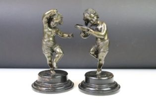 Pair of neoclassical cast bronze figures in the form of children dancing with instruments. both