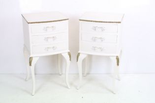Pair of French style White Bedside Cabinets with gilt trim, each with three drawers and raised on