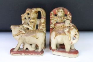 A collection of four Indian carved stone hand painted figures.